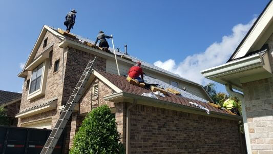 Roof replacement installing new shingles on roof in The Woodlands