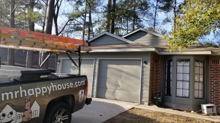 Newly painted house with a light garage trim remodel and an exterior paintjob in The Woodlands, Texas