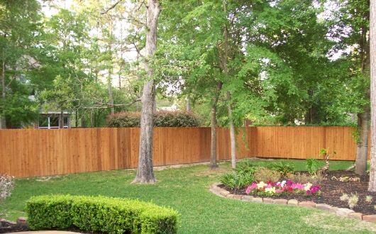 Newly built treated wood and stained fence in The Woodlands Texas