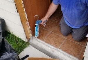 Removing Door and inserting polyurethane sealer to keep door sealed during door in place