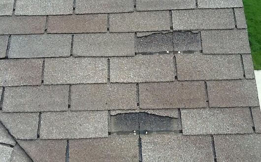 torn off roof shingles on a 3 tab roof most likely caused by wind damage in Magnolia Texas