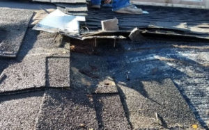 badly damaged roof spot and preparing to repair the roof damage that was done by a previous roofer in The Woodlands, Texas