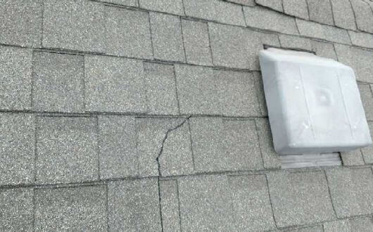 cracked shingles on roof in Tomball Texas