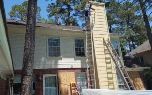hardie siding installation on exterior chimney in the back of a house