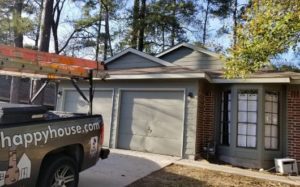 new garage door trim and siding replacement in The Woodlands Texas