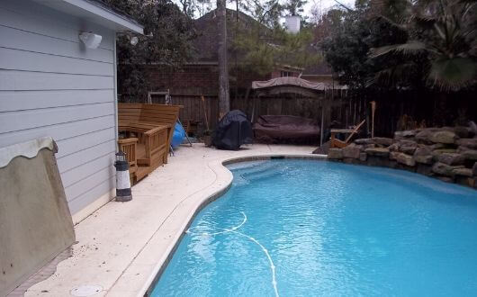 new pool surface cleaning and pressure washed pool deck in The Woodlands Texas