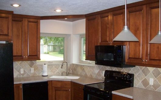new refinished and painted kitchen cabinets with new replacement windows in The Woodlands Texas
