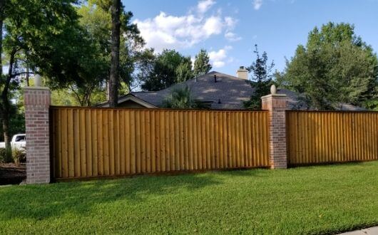 painted and treated wood fence in The Woodlands Texas