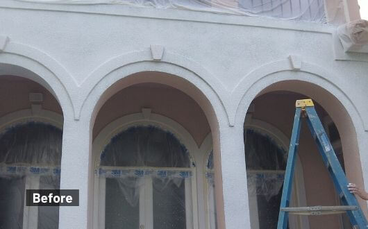 painting exterior stucco home in The Woodlands Texas