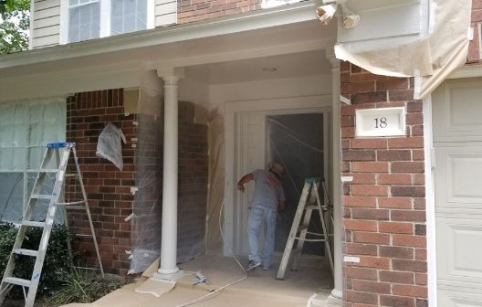 painting the front entry a white color in The Woodlands, Texas