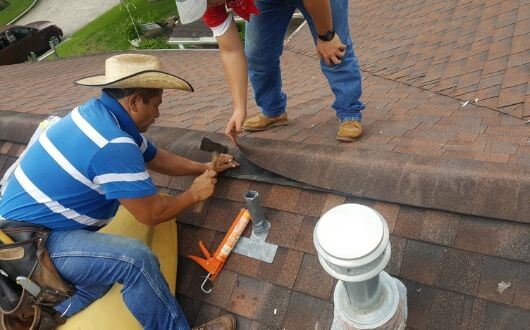 roofer fixing roof damage on roo ridge cap shingles in The Woodlands texas