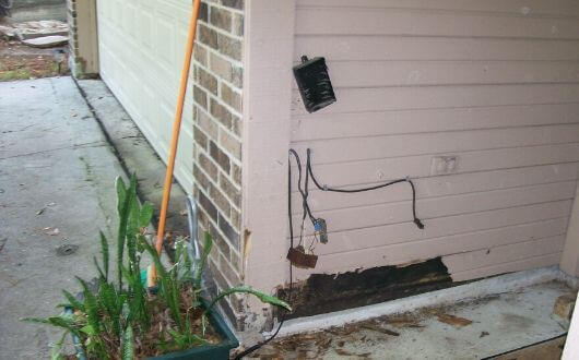 rotted wood siding in front of house