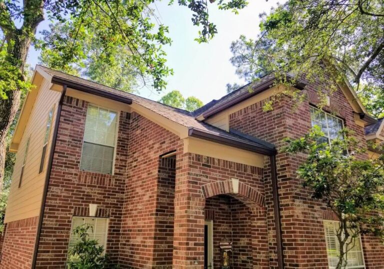 New siding and exterior painting and seamless gutters on house in The Woodlands, Texas